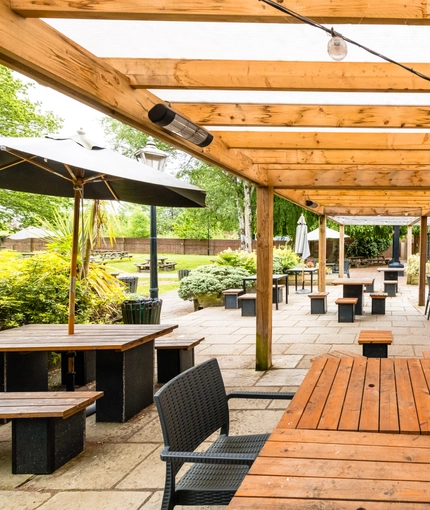 Exterior beer garden and dining area of a pub.