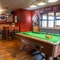 The interior restaurant seating and gaming area, with a dartboard and a pool table.