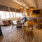 Interior dining area of a pub with a bar and a TV.