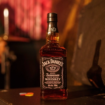 A bottle of Jack Daniels on a bar.