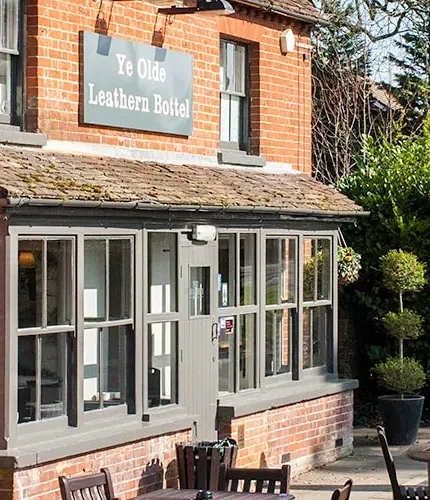 External view of a pub with outdoor seating area