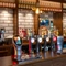 A close up view of the bar inside The Wall's End in Wallsend, with bottles of wine and alcoholic spirits on wooden shelves behind the counter.