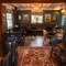 The interior restaurant seating area at the Ye Olde Leathern Bottel in Barkham, with wooden flooring, wooden beams, and an upholstered booth seat beneath the windows.