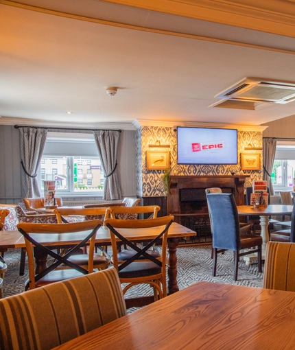The interior restaurant and seating area with TV at the Poachers 