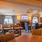 The interior restaurant and seating area with TV at the Poachers 