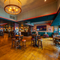 The bar and interior restaurant seating area at the Scholars Arms; with a TV on the wall.