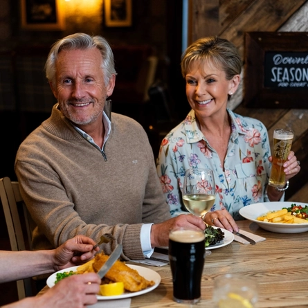 Two people enjoying a meal in a pub