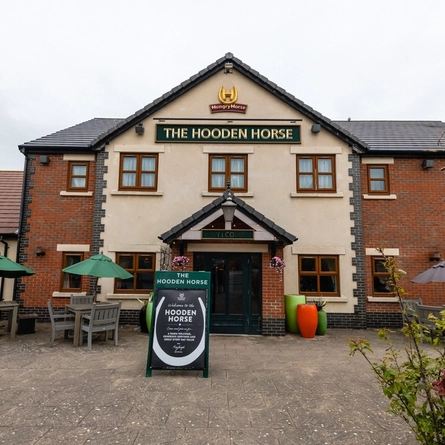 The exterior entrance to the venue and seating area at The Hooden Horse.