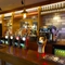 A close up view of the bar inside The Steam Turbine in Rugby, with bottles of wine and alcoholic spirits on shelves behind the counter.