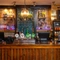 A close up view of the bar and beer taps at the Rudds Arms; with bottles of alcoholic spirits on illuminated shelves behind the counter.