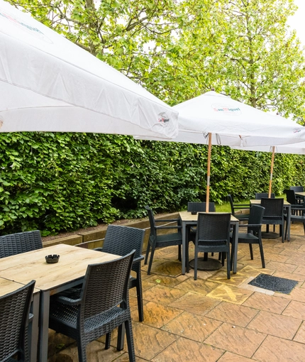 Exterior beer garden of a pub with a seating area.