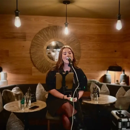 An image advertising a live music What's On event featuring Megan Kate at The Four Oaks.