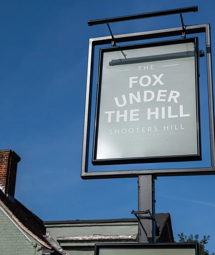 A close up of the signage outside of a pub