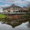 The exterior facade of The Malthouse Farm in Whittle-Le-Woods, with a view of the waterside beside the building.