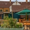 The beer garden with tables and parasols at The Red Lion, Adderbury.