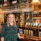 The General Manager of the Prince Of Wales standing in front of the bar.