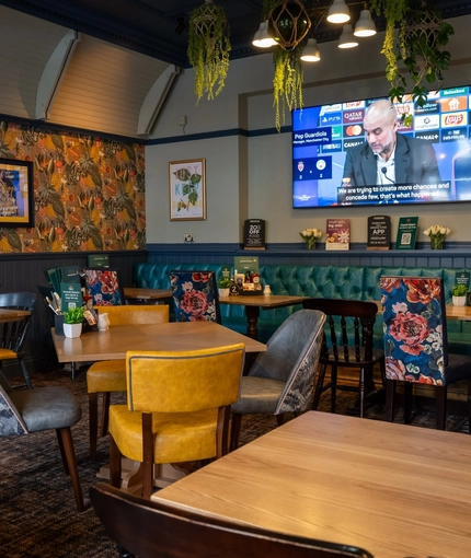 The interior restaurant and seating area with TV at the Ship and Royal.
