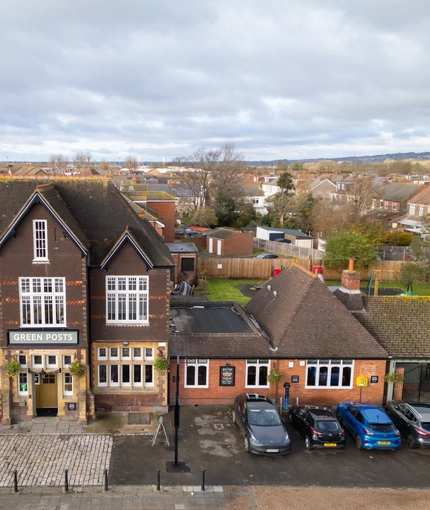 An aerial view of the exterior facade, signage, and car park of the Green Posts in Portsmouth.