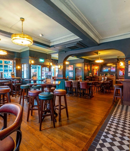 The interior restaurant and seating area with bar and TV at the Fitzrovia.