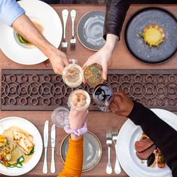 An interior shot of people enjoying food & drinks in the restaurant area at the Ubiquitous Chip in Glasgow.