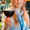 A team member holding up a glass of red wine.