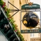 A close up view of the pub sign hanging on the exterior wall of The Globe in Marylebone. The sign features a three-dimensional, black and gold globe within a dark green metal frame below the Greene King logo, and above the words "The Globe" in gold letters.