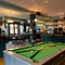 The bar and interior restaurant seating area at The Richmond Arms, with a pool table, bar stool seating, and gaming machines.