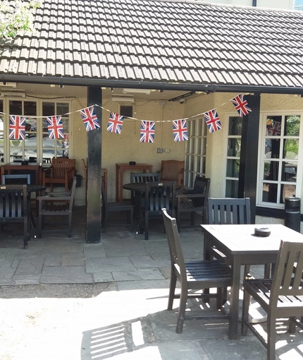 exterior beer garden of a pub with a seating area