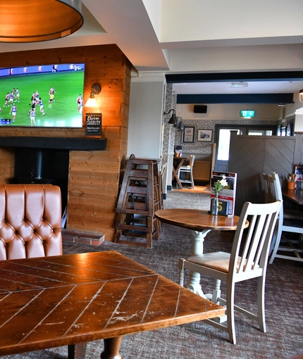interior of the restaurant and seating area with TV