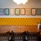 An interior restaurant seating area at the Tredegar Arms, with an upholstered booth seat, and framed artwork on the wall above it.