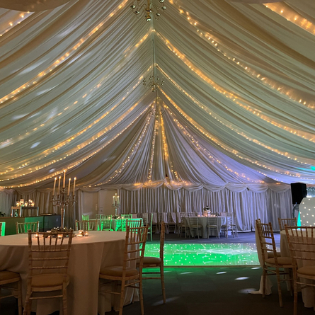 A marquee, decorated for a wedding.