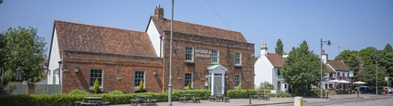 An exterior shot of the seating area & signage at the George & Dragon in Hazel Grove.