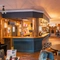 The bar and interior restaurant seating area with fireplace, TV and pub games, at The Belfry in Beighton.