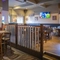 Interior dining area of a pub with a TV.