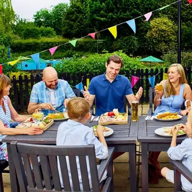 A family eating and drinking outside in a beer garden