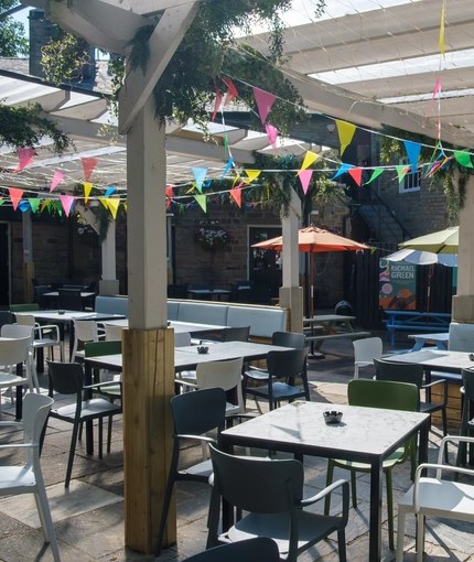 The exterior beer garden seating area with partial covered area at The Hare & Hounds.