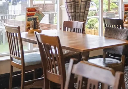 Interior dining area of a pub with a TV.