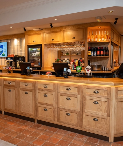 The interior bar area and cake cabinet with tiled flooring at The Farmhouse Kitchen Willington.