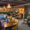 The interior restaurant and seating area with fireplace at The Bell.