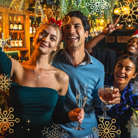 Friends taking a Christmas selfie in the pub