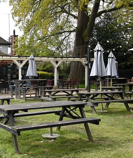 Exterior beer garden of a pub with a gazebo.