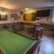 Interior games area of the pub with a pool table and the dartboard