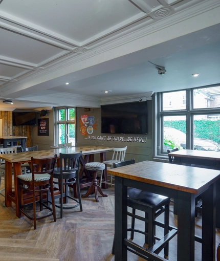 Interior dining area of a pub with a TV.