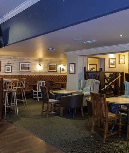 Interior dining area of a pub with a TV.