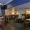 Interior dining area of a pub with a TV.