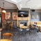 Interior dining area of a pub with a TV and a fireplace.