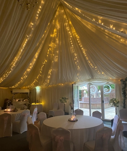 A marquee, decorated for a wedding.