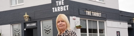 A woman stood outside The Tarbet, looking at the camera.