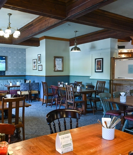 Interior dining area of a pub with a TV.