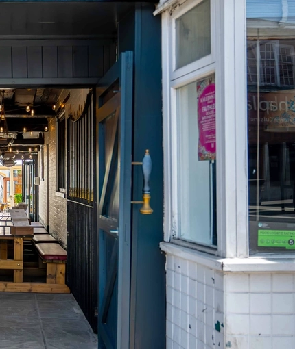 The alleyway entrance to the beer garden at Ye Olde Mitre in Barnet.